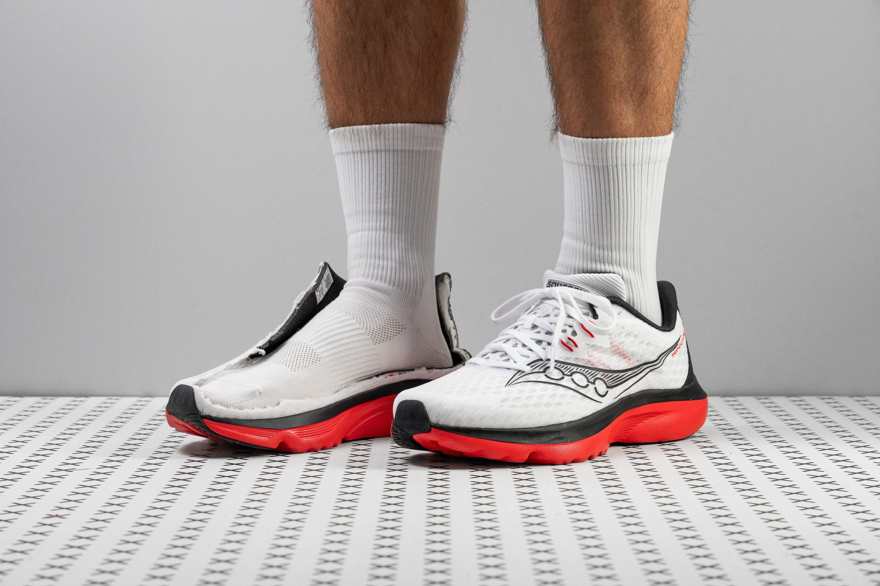 Performance running shoes on a track surface with dramatic lighting
