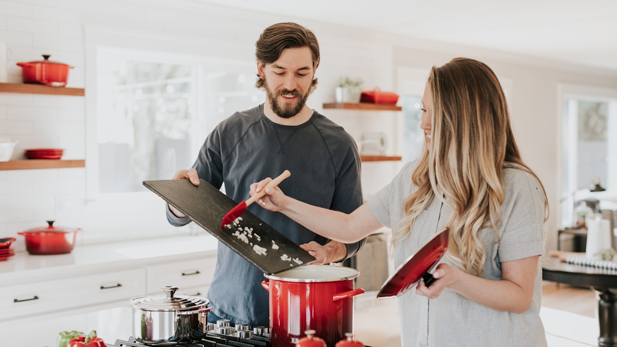 Gleaming stainless steel pans and pots on a kitchen counter