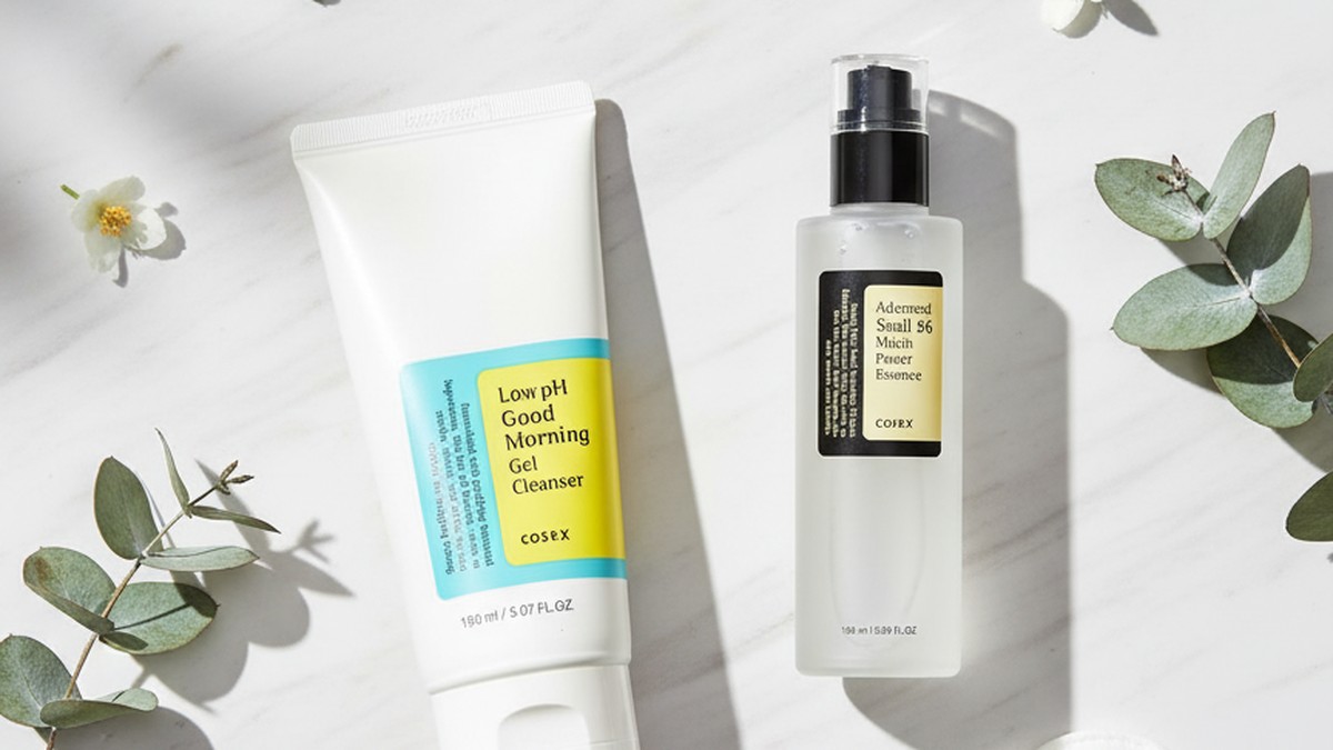 Korean skincare products laid out for a post-workout routine with a gym towel and water bottle